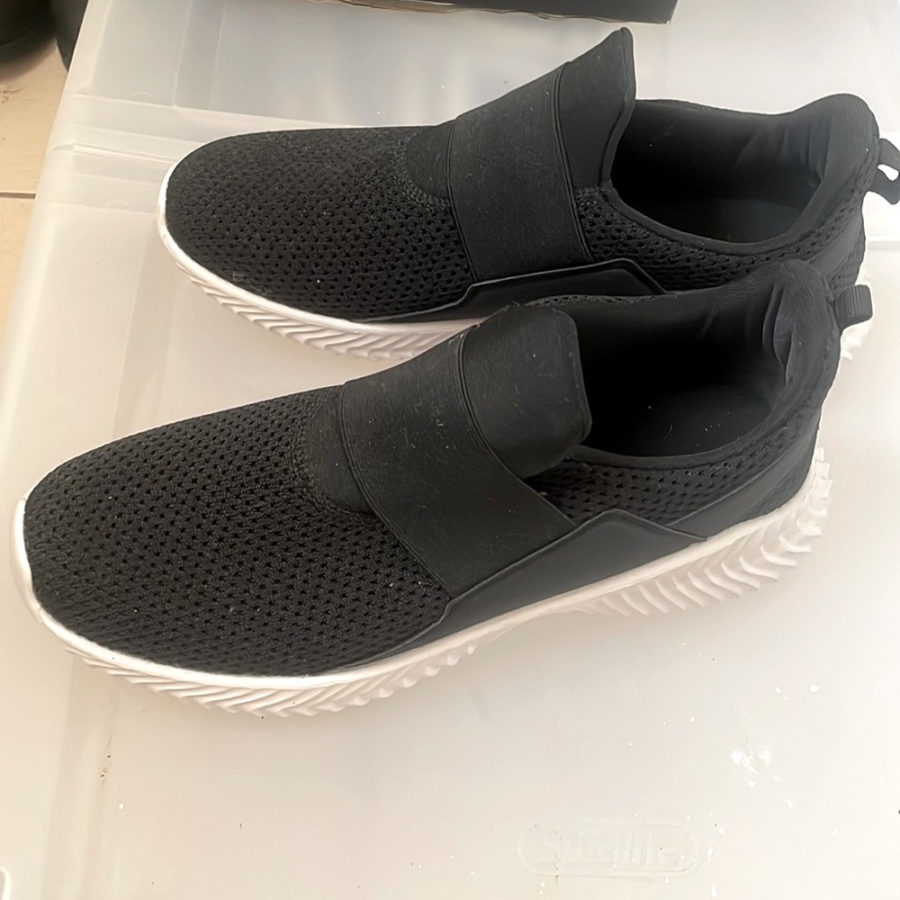 black sneakers with a white bottom